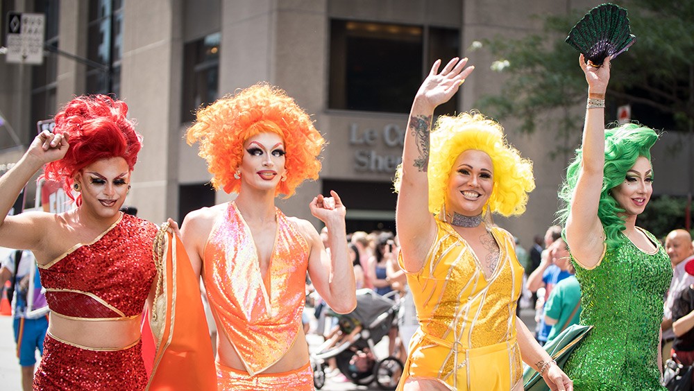 four people in drag at a Pride march