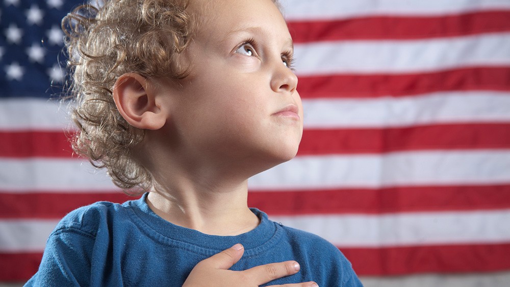 child with hand over heart for pledge of allegiance