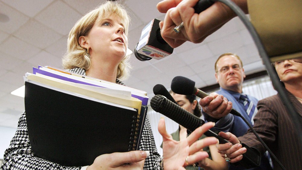 A woman speaks to reporters after a hearing attempting to ban the Harry Potter book series from schools.