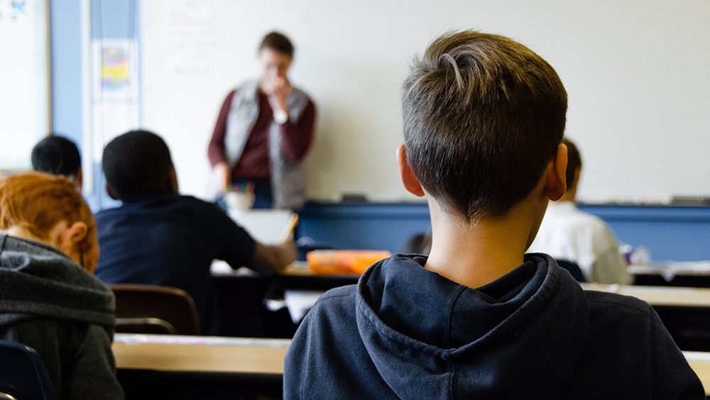 student sitting in school classroom