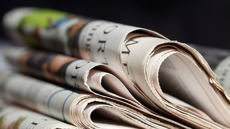 stacked newspapers