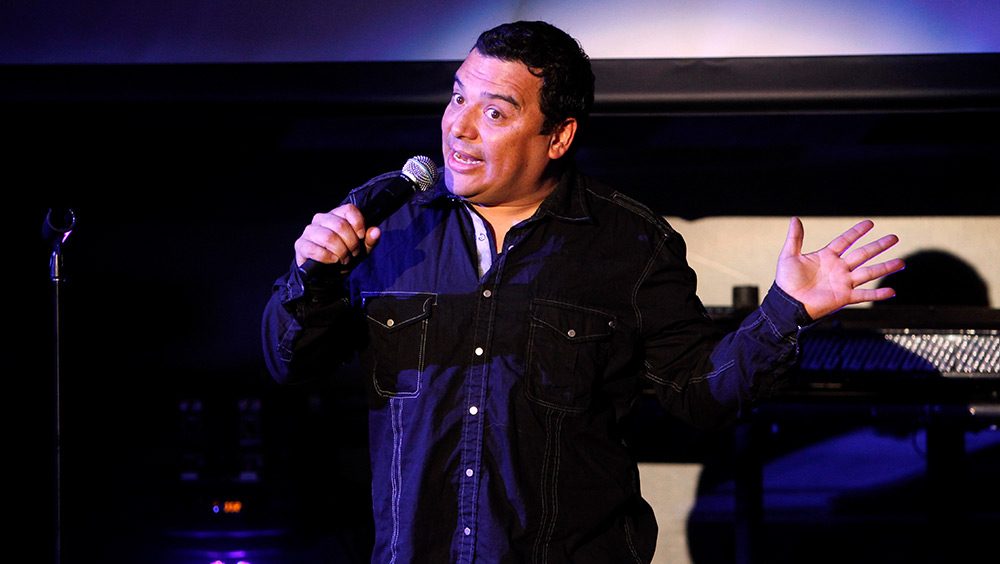 Carlos Mencia performs on stage