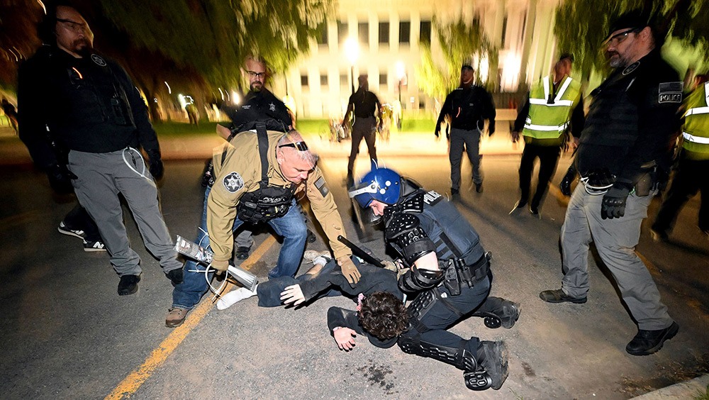 Police officers arresting protestor
