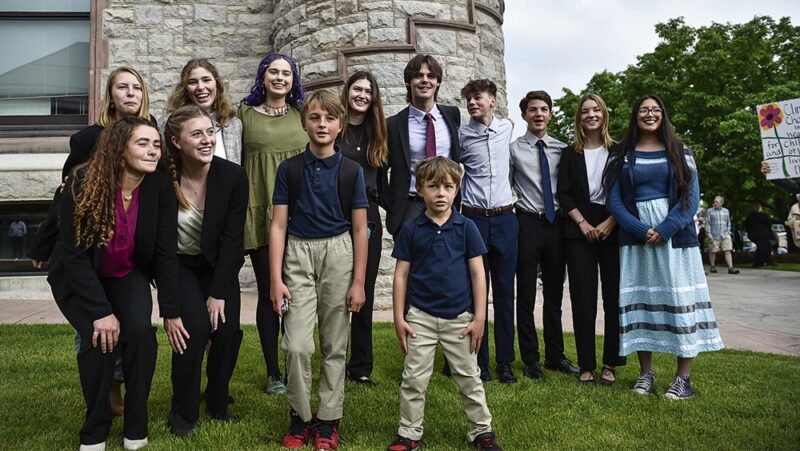 Youth plaintiffs in the climate change lawsuit, Held vs. Montana, pose outside the Lewis and Clark County Courthouse in Helena, Montana.