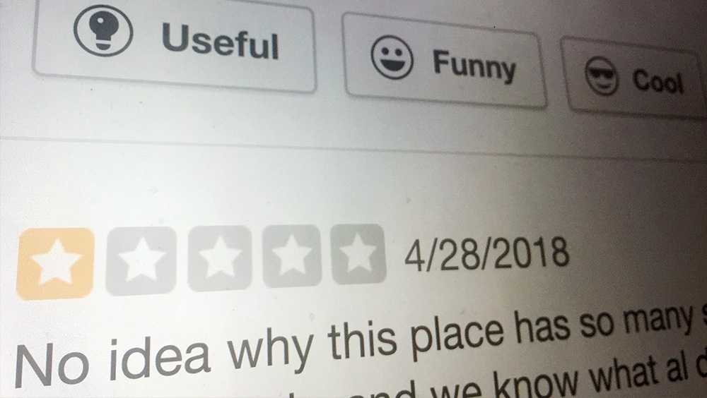 Photo of computer screen showing one-star review criticizing restaurant