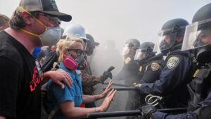Protesters confront police on the 101 Freeway near the Metropolitan Detention Center of downtown Los Angeles, Sunday, June 8, 2025