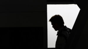 A silhouetted image of Brad Pitt against a bright white background