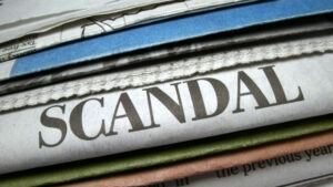 An image of a stack of newspapers, with one reading "Scandal"