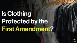 t-shirts hanging on wooden clothes hangers
