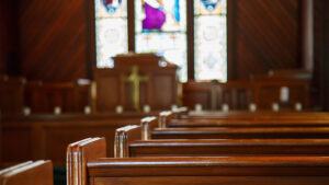 Stained glass windows in small church with wood pews