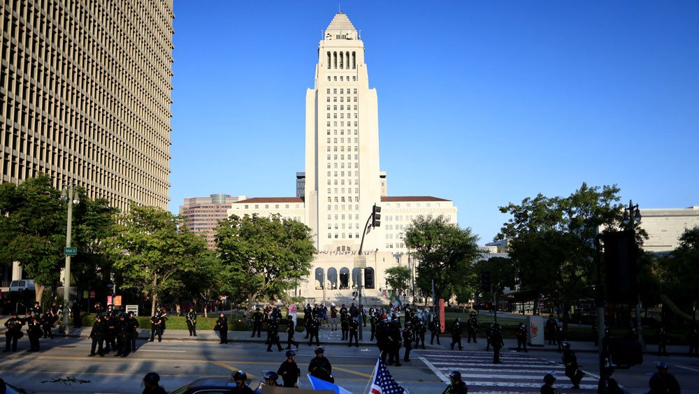 A view of Los Angeles city hall against a blue sky