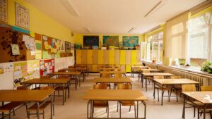 Interior shot of a classroom filled with empty desks