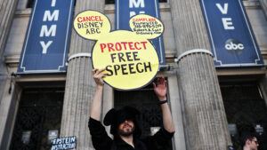 A demonstrator waves a "Protect Free Speech" sign following a protest against the suspension of the "Jimmy Kimmel Live!" show, held near the theater where the show is produced in Hollywood.