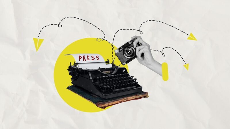 Illustrated collage depicting a hand holding a camera, in front of a typewriter displaying a piece of paper that reads 