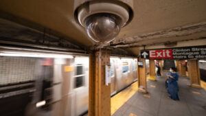 A video surveillance camera attached to the ceiling of a subway station in New York City