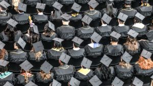 An aerial shot of graduates wearing black caps and gowns